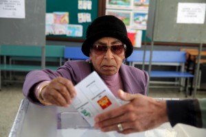 Turkish Cypriot woman casts her vote at a polling station in Famagusta
